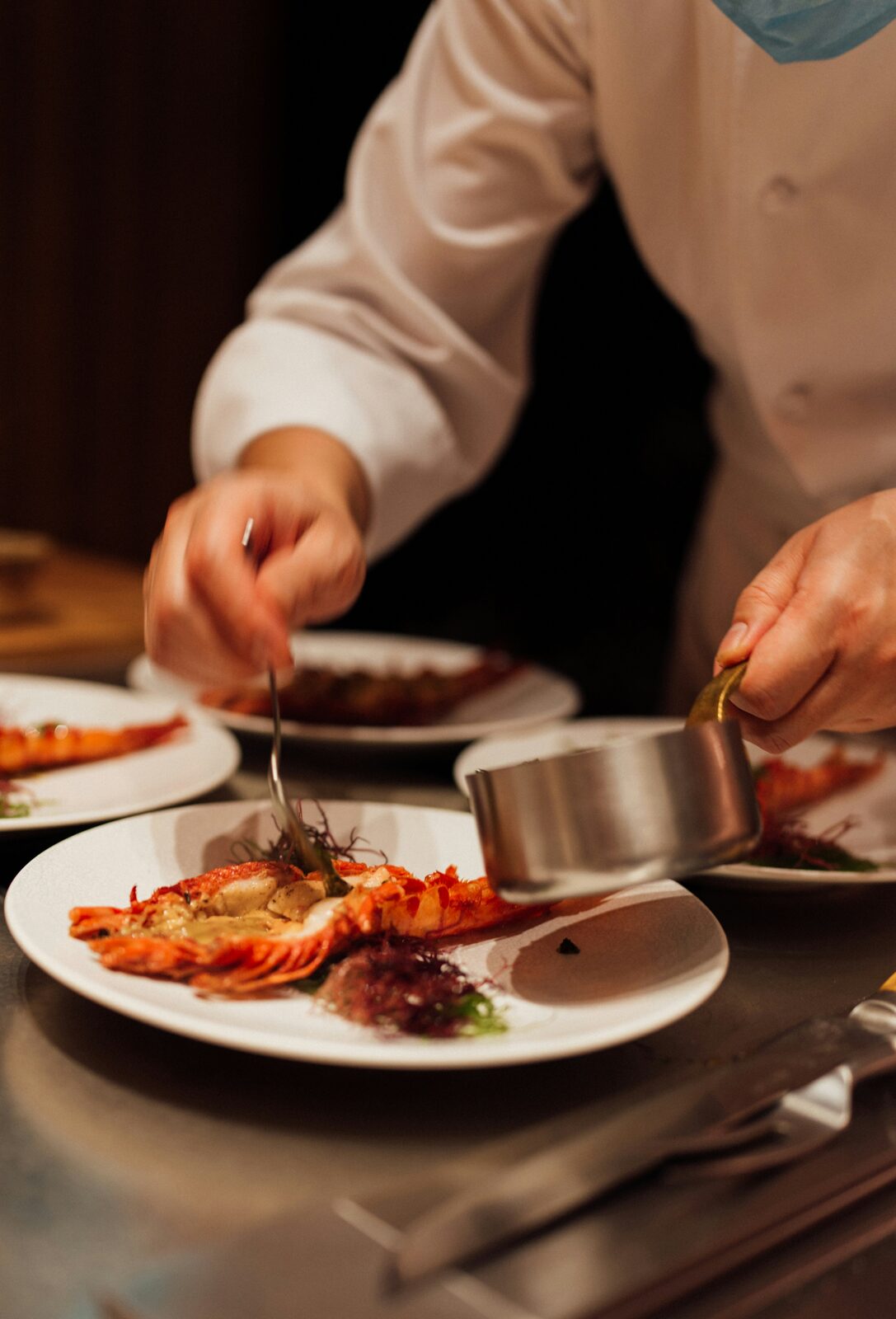 Chef plating a seafood dish